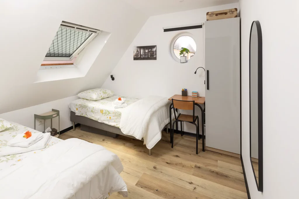 Two single beds with skylight window — Studio 2 loft bedroom Les Trois Cœurs