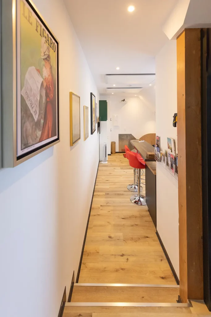Corridor with vintage art gallery wall — Les Trois Cœurs Alsace