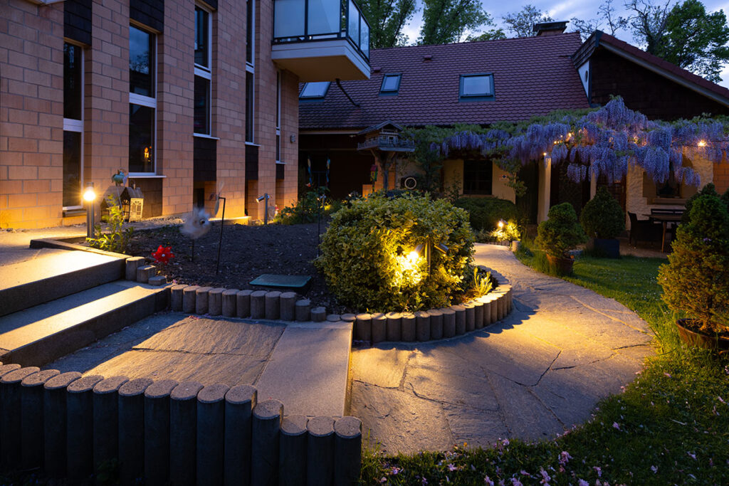 Illuminated walkways leading to the studio.